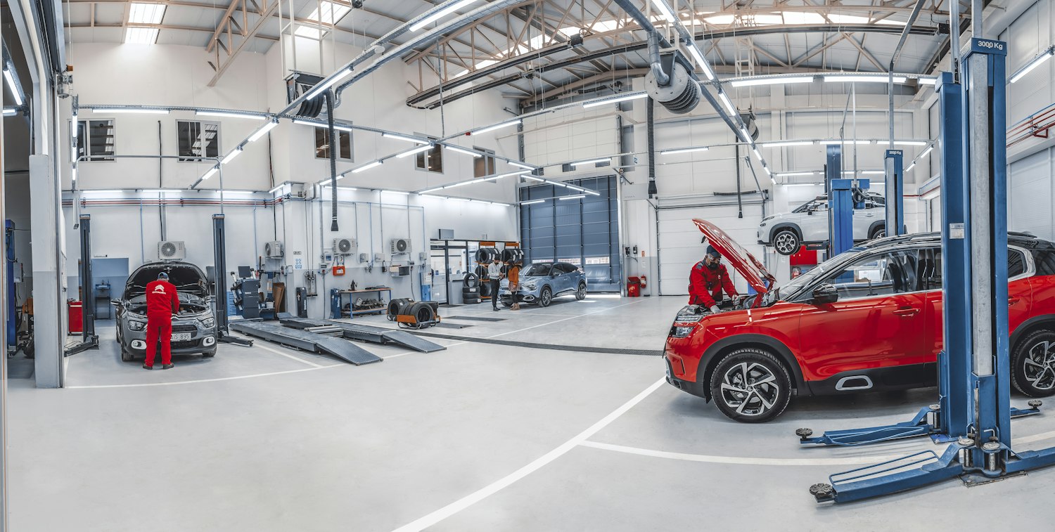 Car workshop with vehicles on lifts